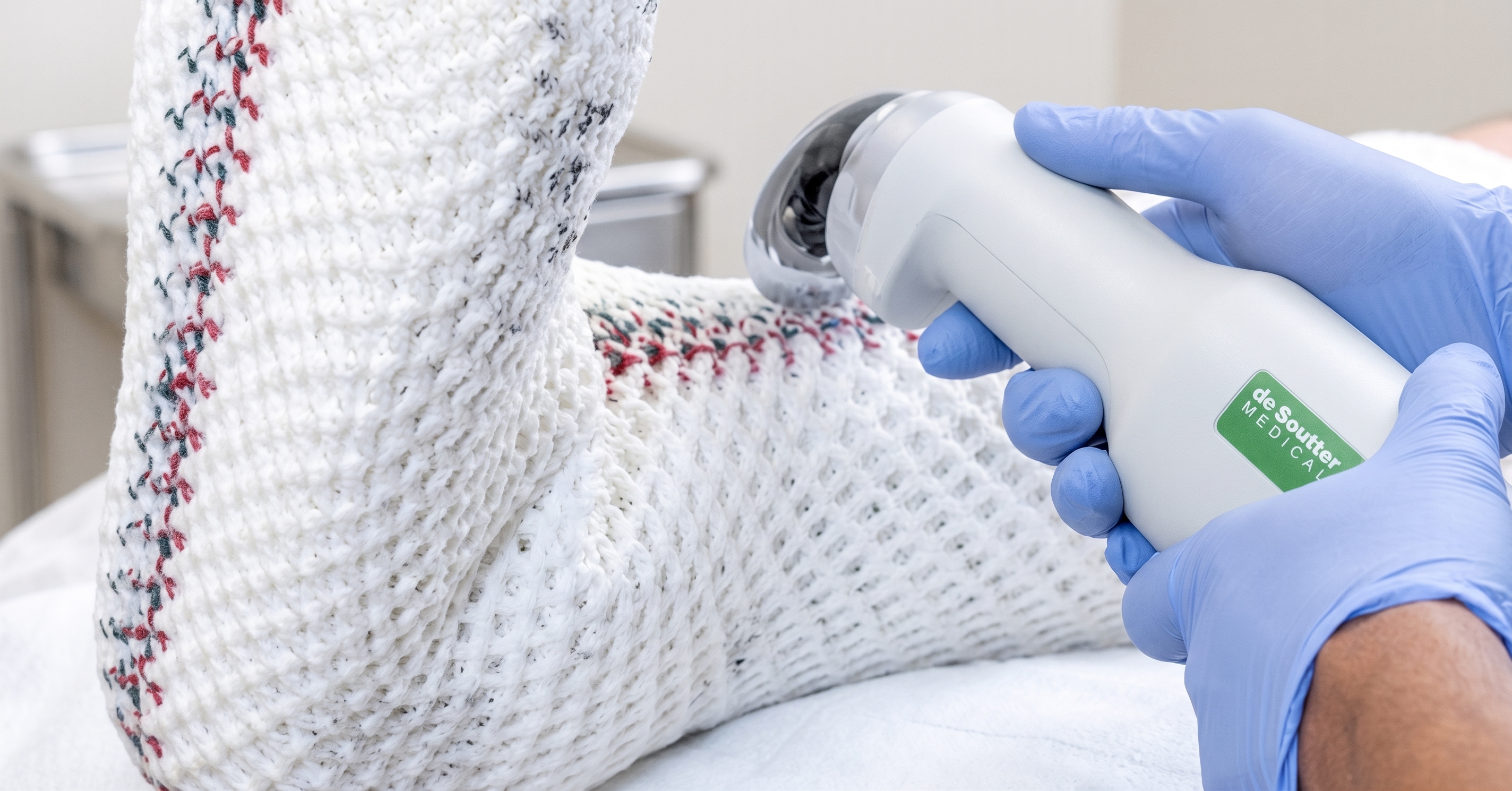 A cast being removed from a patient's lower leg